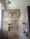 Close up of Brushed nickel rain shower and massage shower head.  